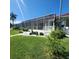Landscaped backyard with screened patio at 2259 Ryan Blvd, Punta Gorda, FL 33950