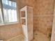 Walk-in shower with tile surround and built-in shelving at 2259 Ryan Blvd, Punta Gorda, FL 33950