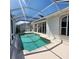 Inviting screened pool with spa and canal view at 2259 Ryan Blvd, Punta Gorda, FL 33950