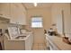 Laundry room with washer, dryer, and cabinets at 2259 Ryan Blvd, Punta Gorda, FL 33950