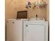 Laundry room with washer, dryer, and shelving at 1516 Natrona Dr, North Port, FL 34286
