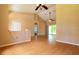 Open living area with vaulted ceilings and hardwood floors at 1516 Natrona Dr, North Port, FL 34286