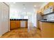 Kitchen features wood cabinets, tile floors, and a breakfast bar at 1516 Natrona Dr, North Port, FL 34286