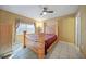 Spacious bedroom with a wooden bed frame and ceiling fan at 25050 Sandhill Blvd # A4 Bldg 2, Punta Gorda, FL 33983