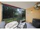 Screened patio with table and chairs, perfect for outdoor dining at 25050 Sandhill Blvd # A4 Bldg 2, Punta Gorda, FL 33983