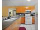 View of the kitchen with white appliances and wood cabinets at 25050 Sandhill Blvd # A4 Bldg 2, Punta Gorda, FL 33983