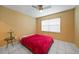 Bedroom with red bedspread and ceiling fan at 25050 Sandhill Blvd # A4 Bldg 2, Punta Gorda, FL 33983