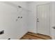 Laundry room with wire shelving and wood flooring at 4637 Corbett Ln, North Port, FL 34288