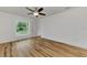 Bedroom with wood flooring, ceiling fan and large window at 4637 Corbett Ln, North Port, FL 34288
