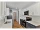 Modern kitchen with white cabinets, stainless steel appliances, and quartz countertops at 4637 Corbett Ln, North Port, FL 34288