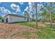 Large backyard with grassy area and mature trees at 4637 Corbett Ln, North Port, FL 34288