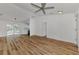 Bright living room with wood-look floors and ceiling fan at 4637 Corbett Ln, North Port, FL 34288