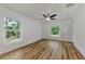Bedroom with wood flooring, ceiling fan and two windows at 4637 Corbett Ln, North Port, FL 34288