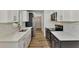 Renovated kitchen featuring white and dark blue cabinets and wood flooring at 4637 Corbett Ln, North Port, FL 34288