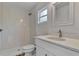 Updated bathroom with white vanity and shower at 4637 Corbett Ln, North Port, FL 34288