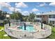 Kidney shaped community pool with surrounding fence and patio at 22333 Edgewater Dr # B8, Port Charlotte, FL 33980