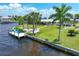 Aerial view showcasing home's waterfront location, lush landscaping, and private dock at 374 Severin Se Rd, Port Charlotte, FL 33952