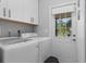 Laundry room with washer, dryer, and exterior access at 374 Severin Se Rd, Port Charlotte, FL 33952