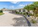 White, single-story home with circular driveway and mature landscaping at 374 Severin Se Rd, Port Charlotte, FL 33952