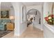 Elegant entryway with arched hallways, tiled floors, and a view of the pool at 374 Severin Se Rd, Port Charlotte, FL 33952