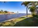 Stunning waterfront view with lush landscaping and palm trees at 374 Severin Se Rd, Port Charlotte, FL 33952