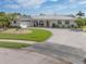 Single-story home with circular driveway and manicured lawn at 374 Severin Se Rd, Port Charlotte, FL 33952