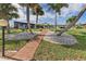 Brick pathway meanders through a beautifully landscaped yard at 374 Severin Se Rd, Port Charlotte, FL 33952