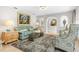 Spacious living room featuring a teal sofa and stylish decor at 374 Severin Se Rd, Port Charlotte, FL 33952
