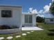 Back exterior of a mobile home with landscaping at 5505 Holiday Park Blvd, North Port, FL 34287