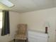 Bedroom with floral armchair and dresser at 5505 Holiday Park Blvd, North Port, FL 34287