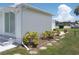 Side view of a white mobile home with landscaping at 5505 Holiday Park Blvd, North Port, FL 34287