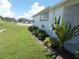 Landscaped yard and white mobile home exterior at 5505 Holiday Park Blvd, North Port, FL 34287