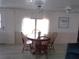 Bright dining area with round wooden table and four chairs at 5505 Holiday Park Blvd, North Port, FL 34287