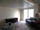 Bright living room featuring a comfortable couch and sliding glass doors at 5505 Holiday Park Blvd, North Port, FL 34287