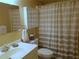 Bathroom with striped shower curtain and vanity at 5505 Holiday Park Blvd, North Port, FL 34287