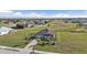 Aerial view of a single-Gathering home with a large yard and surrounding community at 17314 Cape Horn Blvd, Punta Gorda, FL 33955