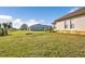 Green grassy backyard with a view of the neighboring house at 17314 Cape Horn Blvd, Punta Gorda, FL 33955