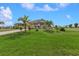 One-story house with palm trees and a large front yard at 17314 Cape Horn Blvd, Punta Gorda, FL 33955