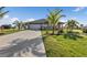 Single-Gathering home with tile roof, palm trees, and a long driveway at 17314 Cape Horn Blvd, Punta Gorda, FL 33955