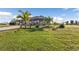 Single-story home with palm trees and a spacious lawn at 17314 Cape Horn Blvd, Punta Gorda, FL 33955