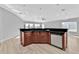 Modern kitchen island with dark countertops and stainless steel appliances at 17314 Cape Horn Blvd, Punta Gorda, FL 33955