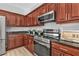 Modern kitchen with dark wood cabinets, granite countertops, and stainless steel appliances at 17314 Cape Horn Blvd, Punta Gorda, FL 33955