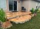 Relaxing patio with stone tile flooring, potted plants, and lounge chairs at 17314 Cape Horn Blvd, Punta Gorda, FL 33955