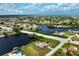 Canal-front property featuring a single-story home and private pool at 2484 Broad Ranch Dr, Port Charlotte, FL 33948