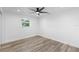 Light and airy bedroom, featuring wood-look floors and a window at 130 Concord Ne Dr, Port Charlotte, FL 33952