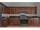 Kitchen with dark wood cabinets, granite countertops and stainless steel appliances at 17314 Cape Horn Blvd, Punta Gorda, FL 33955