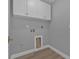 Bright laundry room with white cabinets and gray walls at 17314 Cape Horn Blvd, Punta Gorda, FL 33955