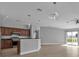Open kitchen with dark wood cabinets, granite countertops, and stainless steel appliances at 17314 Cape Horn Blvd, Punta Gorda, FL 33955