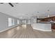 Open concept living room and kitchen with vinyl plank flooring and modern light fixtures at 17314 Cape Horn Blvd, Punta Gorda, FL 33955