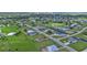 Aerial view of a neighborhood with houses, canals, and lush greenery at 17314 Cape Horn Blvd, Punta Gorda, FL 33955